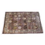 A Persian silk and gold thread garden design rug by Imperial Jewel, with thirty panels of vase and