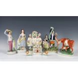 A collection of Staffordshire Pottery flat back figures and others, of varying sizes and models,