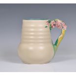 A Clarice Cliff jug, c.1936, moulded floral, leaf and stem handle, ribbed body, printed Newport