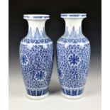 A pair of large Chinese blue and white lotus scroll baluster vases, 20th century, decorated with