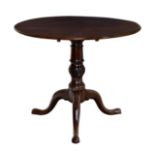 A George III mahogany circular tilt-top tripod table, the well figured top on a spiral fluted,