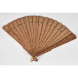 A Chinese carved sandalwood brise fan, 19th century, the guards decorated with numerous figures in