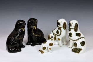 A group of five 19th century Staffordshire dogs, comprising a pair in black glaze with gilt