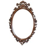 An oval wall mirror in the Italian 18th century style,