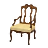 A French carved oak open armchair in the Louis XIV style, probably early 20th century, the waisted