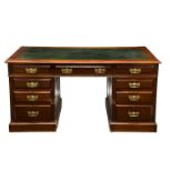 An Edwardian mahogany pedestal desk, with gilt tooled inset green leather top over three frieze