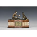 A 1930s French Art Deco marble, onyx and bronzed spelter mantel clock, the rectangular silvered dial