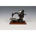 An early Willcox & Gibbs Sewing Machine, with original carrying box. Serial number A494338