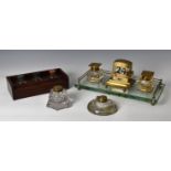 An early 20th century glass and brass desk stand, of rectangular form, the glass base with