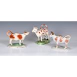Three Staffordshire Cow Creamers, various glazes, in white, browns, oranges and pink lustre, tallest