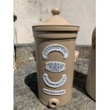 A 19th century stoneware water filter, by John Mellor, having applied plaques to the front, domed