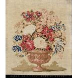 A 19th century needlework sampler, depicting flowers in an urn, mirrored title band to base 'SARAH