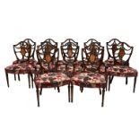 A set of twelve Victorian mahogany dining chairs in the Hepplewhite shield back style, including two