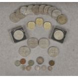 A collection of twenty-nine coins comprising sixteen British commemorative crowns, two boxed,