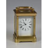 A miniature brass carriage clock by Elliot & Sons, London 20th Century, with five bevelled glass