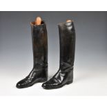 A pair of black leather riding boots with wooden stretchers c.1965, made by Long Buckby Shoes Ltd,
