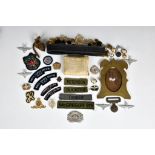 A rummage tray of Military related collectables to include a trench art brass photo frame, inscribed