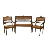 A three piece French beechwood and caned parlour suite the carved top rail over a caned back and