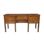 A George IV mahogany and ebony inverted breakfront sideboard with central fitted cutlery drawer with
