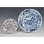 A large Delft charger 18th century, painted in blue and white in the Chinese manner with a bird,