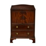 A George III mahogany bedside night table cabinet the tray top with wavy gallery, over a two-door