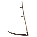 An antique double handled scythe with elm handle 59½in. (151cm.) long, the blade 34in. (86.3cm.)