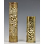 Two Trench Art brass shell vases both beaten with raised flower decoration, the tallest 13 ¾in. (