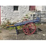 A Guernsey blue and red painted handcart, or 'goat-cart' the wooden cart painted in traditional blue
