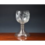 A Victorian oversized glass gobletwith etched decoration of Bacchus amidst grape vines, raised on