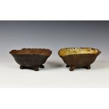 Two novelty Victorian cast iron dog bowls fashioned as inverted tortoises the larger with indistinct