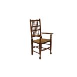 A late 19th century Lancashire style spindle back chair the attractive back with triple rails