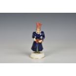 A Staffordshire porcelaneous figure of a female hurdy gurdy player mid-19th century, with separately