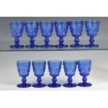 A set of eleven blue French moulded wine glasses approx. 12.7cm. high. (11) *A couple of chips to