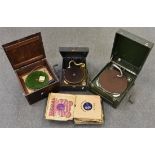Three vintage portable gramophones together with 78 records and spare winding keys.