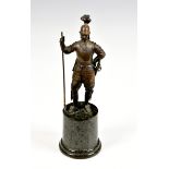A bronze figure of a Cuirassier style soldierunmarked, the soldier standing upon a cylindrical