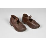 A pair of antique brown leather child's clogs.