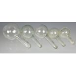 Four blown glass plant watering globes or bottle stoppers probably 19th / early 20th century, in