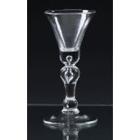 An early 18th century baluster wine glass c.1730, the slightly flared, bell bowl with basal tear