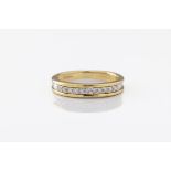 An 18ct two colour gold and diamond half eternity ring hallmarked London 2000, set with eleven