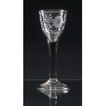 A mid-18th century engraved wine glass c.1745, the ogee bowl engraved with a rose and floral