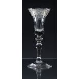An early 18th century engraved light baluster wine glass c.1730, the bell shaped bowl engraved