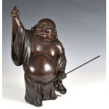 A Chinese bronze figure of the laughing Budai probably Qing Dynasty, early 19th century, with dark