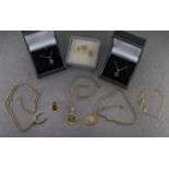 A small group of 9ct gold jewellery including three pendant necklaces, an anchor chain necklace, a