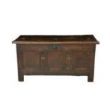 An 18th century three panel coffer the top opening to storage over carved frieze, muntin's and