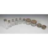 Ten matching clear glass dressing table jars and bottles, with silver screw tops London, F & Co.