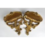 A pair of wooden wall brackets in Rococo style, gilded, 20th century, 9in. high.