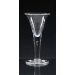 A mid-18th century plain stemmed wine glass c.1745, the heavy gauge, drawn trumpet bowl on a
