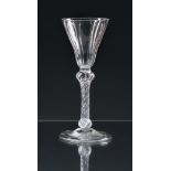 A scarce mid-18th century panel moulded airtwist wine glass c.1750, the slightly waisted, pointed