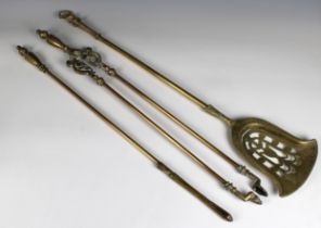 Three Georgian brass fire irons comprising; poker tongues and shovel, with cast knop handles 31½