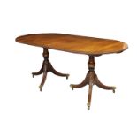 A Regency style mahogany D-end pedestal dining table the inlaid crossbanded top over turned baluster